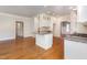 Open-concept kitchen features a center island with granite countertops and seamless flow to the living area at 3034 E Bay Court, Creedmoor, NC 27522