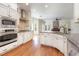 Modern kitchen with stainless steel appliances, white cabinets, and a center island overlooking the living room at 3034 E Bay Court, Creedmoor, NC 27522