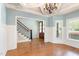 Spacious living area with hardwood floors, wainscoting, and a view of the staircase at 3034 E Bay Court, Creedmoor, NC 27522