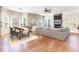 Cozy living room featuring a stone fireplace, hardwood floors, and an adjacent dining area at 3034 E Bay Court, Creedmoor, NC 27522