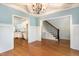 Open living area connects to a kitchen, featuring hardwood floors, wainscoting, and natural light at 3034 E Bay Court, Creedmoor, NC 27522