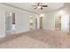 Spacious main bedroom with a tray ceiling, carpeting, and multiple entryways at 3034 E Bay Court, Creedmoor, NC 27522