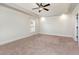 Spacious main bedroom with tray ceiling, ceiling fan and natural light from the large window at 3034 E Bay Court, Creedmoor, NC 27522