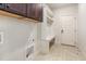 Mudroom boasts built-in bench seating, dark cabinetry, coat hooks, and tile flooring at 3034 E Bay Court, Creedmoor, NC 27522