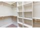 Bright walk-in closet with built-in shelving and hanging rods for optimal storage solutions at 3034 E Bay Court, Creedmoor, NC 27522