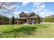 Charming two-story home with stone accents, manicured lawn, and lush landscaping at 3034 E Bay Court, Creedmoor, NC 27522