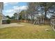 A spacious backyard featuring a wooden fence, patio, and playset at 304 Frontgate Dr, Cary, NC 27519