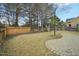 A spacious backyard featuring a wooden fence, patio, and playset at 304 Frontgate Dr, Cary, NC 27519