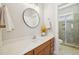 Stylish bathroom features a modern vanity, round mirror, and a shower with mosaic tile accents at 304 Frontgate Dr, Cary, NC 27519