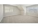 A cozy bedroom featuring neutral walls, carpet flooring, and multiple windows at 304 Frontgate Dr, Cary, NC 27519