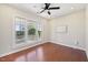 Bright bedroom featuring hardwood floors and a large window overlooking the front yard at 304 Frontgate Dr, Cary, NC 27519