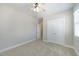 Comfortable bedroom featuring neutral carpet, ceiling fan, closet, and an entrance to an additional room at 304 Frontgate Dr, Cary, NC 27519