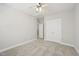 Calm bedroom with soft carpet, closet, ceiling fan, and access to an additional room at 304 Frontgate Dr, Cary, NC 27519