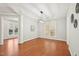 Dining room featuring hardwood floors, a tray ceiling, and modern light fixture at 304 Frontgate Dr, Cary, NC 27519