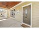 Covered front porch featuring a detailed front door, a ceiling fan, and wood ceiling at 304 Frontgate Dr, Cary, NC 27519