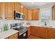 Modern kitchen features white countertops, stainless steel appliances, and wooden cabinets at 304 Frontgate Dr, Cary, NC 27519