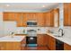 Modern kitchen features white countertops, stainless steel appliances, and wooden cabinets at 304 Frontgate Dr, Cary, NC 27519