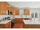 Modern kitchen features white countertops, stainless steel appliances, and wooden cabinets at 304 Frontgate Dr, Cary, NC 27519