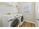 Bright laundry room features modern washer, dryer, and storage shelving at 304 Frontgate Dr, Cary, NC 27519