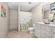 Bright bathroom with a single vanity, floral shower curtain, and shelving for storage at 305 Eastfield Dr, Rocky Mount, NC 27801