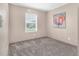 Cozy bedroom featuring neutral walls, plush carpeting, and a bright window for natural light at 305 Eastfield Dr, Rocky Mount, NC 27801