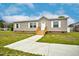 Charming single-story home with a welcoming front porch and freshly painted entrance walkway at 305 Eastfield Dr, Rocky Mount, NC 27801
