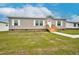 Single-story home featuring low maintenance vinyl siding, a new set of stairs, and freshly mowed grass at 305 Eastfield Dr, Rocky Mount, NC 27801