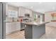 Bright kitchen featuring an island, modern appliances, a stainless steel refrigerator and light wood cabinets at 305 Eastfield Dr, Rocky Mount, NC 27801
