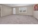 Living room with carpeted floors and windows, perfect for relaxing or entertaining at 305 Eastfield Dr, Rocky Mount, NC 27801