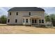 Exterior of home with a covered porch and a large backyard at 308 Busterfield Ct, Benson, NC 27504
