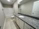 Bright bathroom featuring tub/shower combo, granite countertop, and white cabinets at 308 Busterfield Ct, Benson, NC 27504