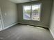 Comfortable bedroom with plush carpeting, a large window, and neutral walls, providing a relaxing atmosphere at 308 Busterfield Ct, Benson, NC 27504