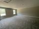 Spacious bedroom with plush carpeting and natural light from two windows at 308 Busterfield Ct, Benson, NC 27504