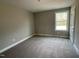 Bright bedroom featuring plush carpeting, a window, and neutral walls, creating a cozy atmosphere at 308 Busterfield Ct, Benson, NC 27504