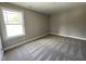 Bedroom with a large window providing views of surrounding nature and a plush carpet at 308 Busterfield Ct, Benson, NC 27504