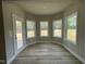 Bright breakfast nook featuring wood-look flooring and three windows allowing for ample natural light at 308 Busterfield Ct, Benson, NC 27504