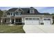 Charming two-story home with a two-car garage and stone accents, enhancing curb appeal at 308 Busterfield Ct, Benson, NC 27504