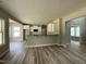 Open kitchen flows to dining and living areas, filled with natural light and wood floors at 308 Busterfield Ct, Benson, NC 27504