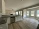 Open concept kitchen with granite counters, stainless appliances, and natural light at 308 Busterfield Ct, Benson, NC 27504