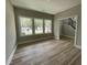 Bright living room featuring large windows and wood flooring, creating an inviting space at 308 Busterfield Ct, Benson, NC 27504