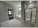 Elegant main bathroom featuring soaking tub, glass enclosed shower, and tile flooring at 308 Busterfield Ct, Benson, NC 27504