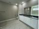 Elegant main bathroom featuring double vanity, granite countertops, tile flooring, and glass enclosed shower at 308 Busterfield Ct, Benson, NC 27504