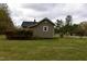 Exterior view of a house, highlighting its spacious backyard and wooden deck for outdoor enjoyment at 312 W Steele St, Gibsonville, NC 27249
