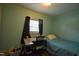 Cozy bedroom featuring a desk, window, and a comfortable twin bed at 312 W Steele St, Gibsonville, NC 27249