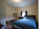 Inviting bedroom featuring a comfortable bed, a window, and a neutral paint at 312 W Steele St, Gibsonville, NC 27249