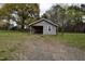 View of an outbuilding with a covered area in a grassy lot at 312 W Steele St, Gibsonville, NC 27249