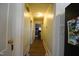 Hallway with hardwood floors, neutral walls, and doors leading to various rooms at 312 W Steele St, Gibsonville, NC 27249