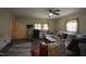 Cozy living room featuring a ceiling fan, warm paint tones, and comfortable seating at 312 W Steele St, Gibsonville, NC 27249