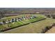 Aerial view of a community with spacious lots, manicured lawns and mature evergreens. Property marked with a red pin at 343 Brinkley Cir, Mebane, NC 27302
