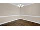 Inviting dining room with hardwood floors, chair rail molding, and stylish light fixture at 343 Brinkley Cir, Mebane, NC 27302